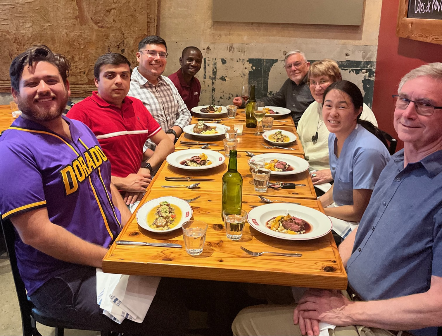 Eight people dining at a large table